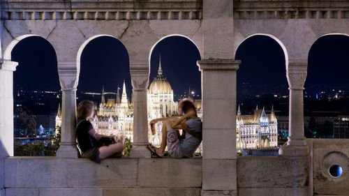 People sitting in front of building