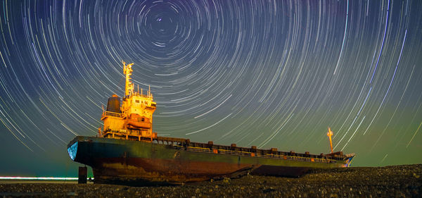Digital composite image of ship against sky at night