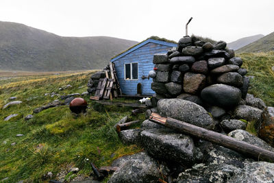 Blue wooden fishing cabin stokkvika at the coast in moskenesoya lofoten islands in norway.