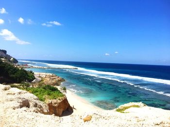 View of calm beach against blue sky