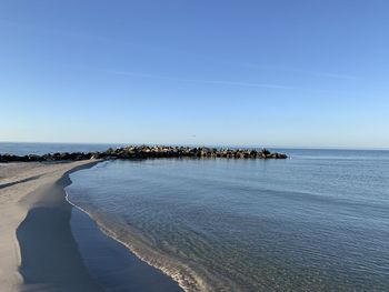 Scenic view of sea against clear blue sky