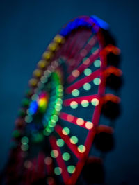 Close-up of illuminated lighting equipment against blue background