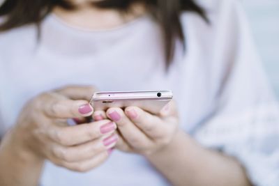 Close-up of woman using mobile phone