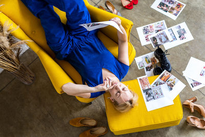 High angle view of woman lying on chair