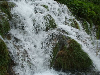 Scenic view of river flowing through rocks