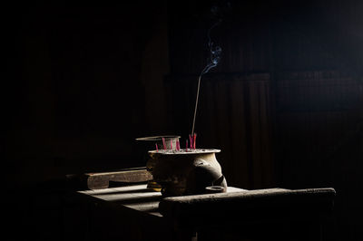 Close-up of drink on table against black background