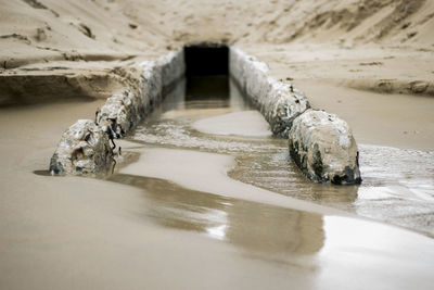 Pov drain on a beach
