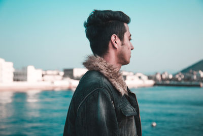 Man standing by sea against clear sky