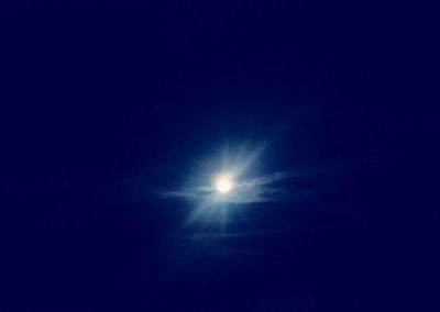 Scenic view of moon against clear blue sky at night