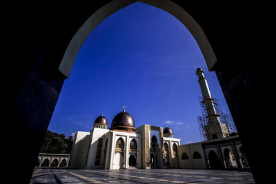 Low angle view of historical building against blue sky