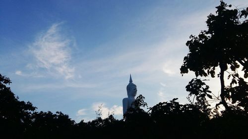 Low angle view of silhouette trees against sky