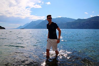 Woman standing on lakeshore