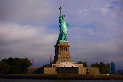 Low angle view of statue of liberty against sky