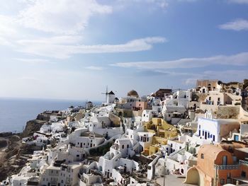 High angle view of townscape by sea against sky