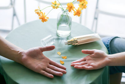 Cropped hands of woman using mobile phone