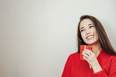 Portrait of a beautiful young woman drinking coffee
