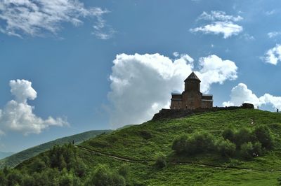 Low angle view of temple against cloudy sky