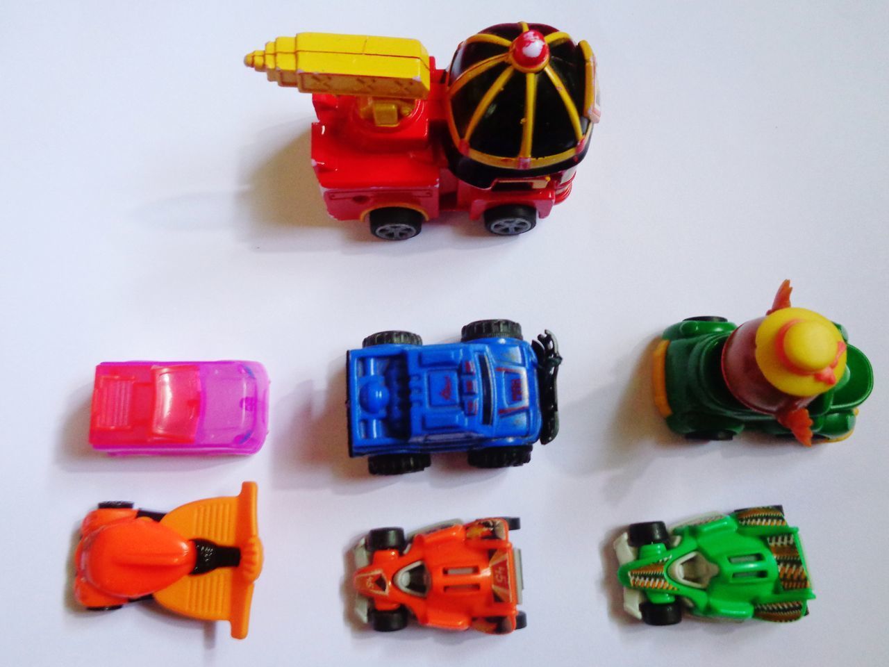 HIGH ANGLE VIEW OF TOYS ON TABLE AGAINST WHITE BACKGROUND