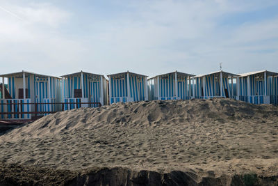 Beach huts against sky