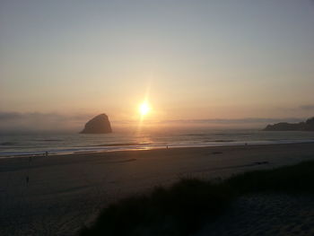 Scenic view of beach against sky during sunset