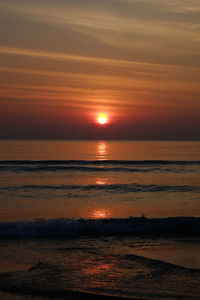Scenic view of sea against romantic sky at sunset