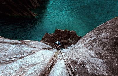 High angle view of man rock climbing