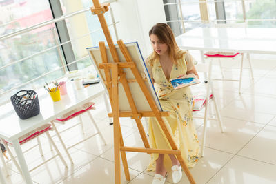 Young woman sitting on table