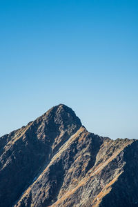 Scenic view of mountains against clear blue sky