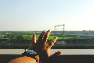 Close-up of boy hand on glass window