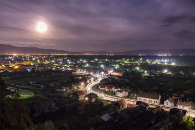 High angle view of illuminated buildings in city at night