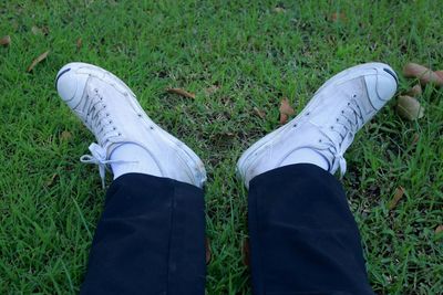 Low section of man standing on field