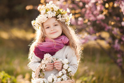 Portrait of cute girl standing at park