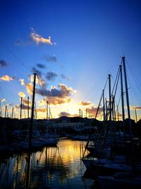 Boats in harbor at sunset