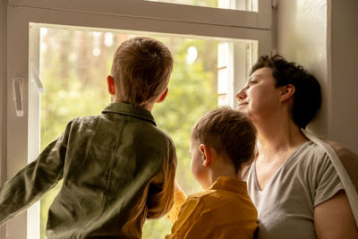 Happy grandmother and her grandsons enjoy time together. positive middle age woman