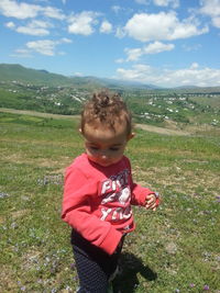 Cute boy standing on field