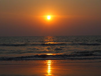 Scenic view of sea against orange sky