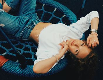 High angle view portrait of woman lying outdoors