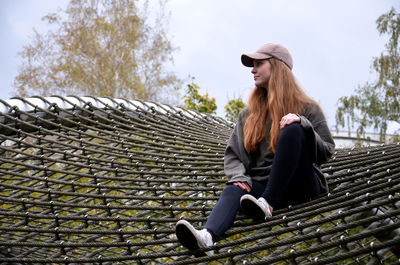 Portrait of young woman sitting outdoors