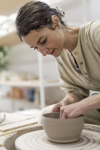 Side view of man working at workshop