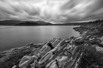 Scenic view of sea and mountains against sky