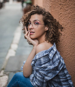 Portrait of young woman sitting outdoors