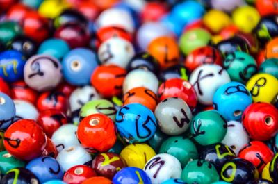 Full frame shot of colorful beads with alphabets