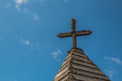 Low angle view of cross against blue sky