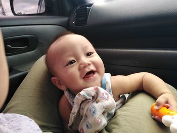 Portrait of cute baby girl in car