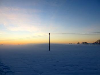 Scenic view of landscape against sky at sunset