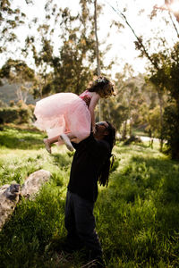 Uncle and niece playing in field