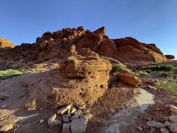 Rock formations on landscape against clear sky