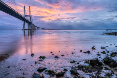 The vasco da gama bridge across the river tagus in lisbon, portugal, at sunrise