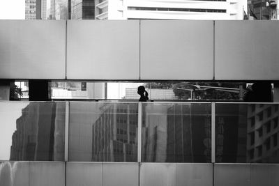 Man walking on modern building in city