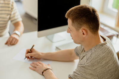 Serious professional man consulting client in office. two mens having meeting